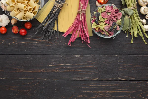 Dry mixed pasta on wooden background, top view — Stock Photo, Image