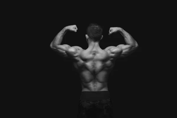 Unrecognizable man shows strong back muscles closeup — Stock Photo, Image