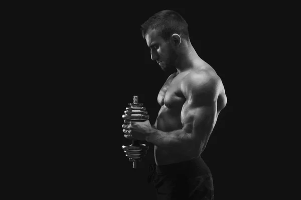 Strong man with dumbbell showing muscular body — Stock Photo, Image