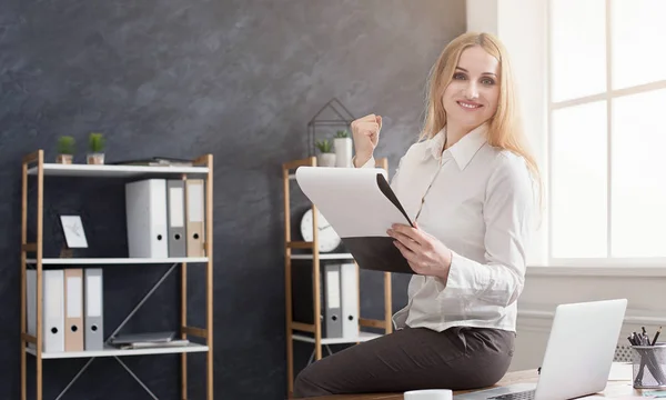 Young insurance agent writing notes while sitting in office — Stock Photo, Image