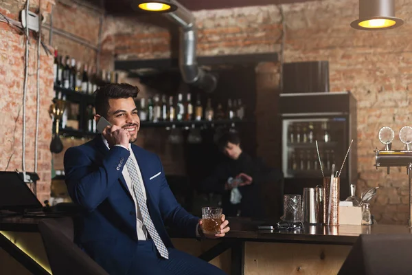 Vrolijke zaken praten over telefoon in bar — Stockfoto