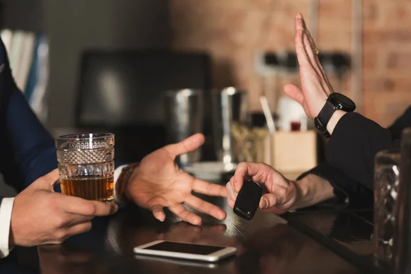 Bartender taking drunk customer car keys