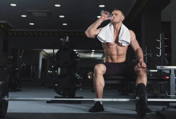 Muscular fisiculturista descanso após deadlifts no ginásio — Fotografia de Stock