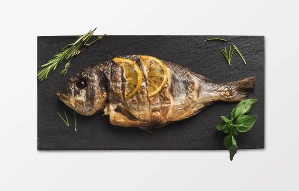 Whole grilled dorado on slate, isolated — Stock Photo, Image