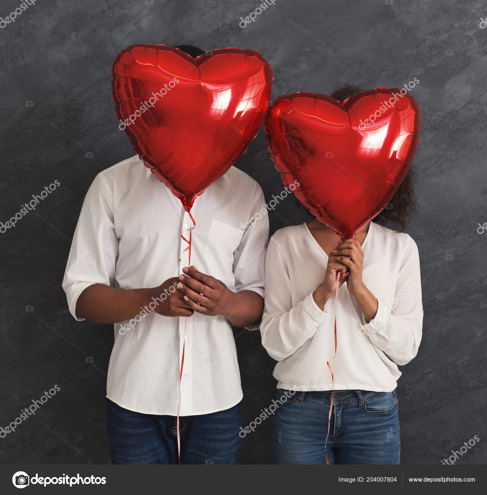Black couple hiding faces behind red balloons Stock Photo by ©Milkos  204007804