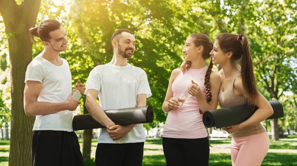 Group of people talking after exercising at park