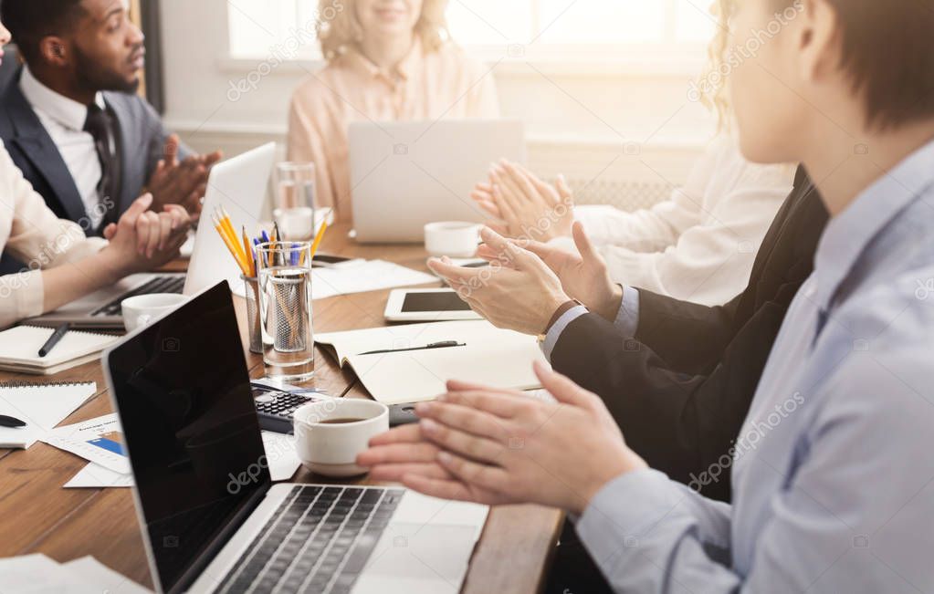 Glad partners clapping hands after business meeting or seminar. Professional education, presentation or coaching concept