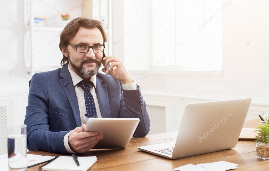 Serious businessman talking on mobile phone