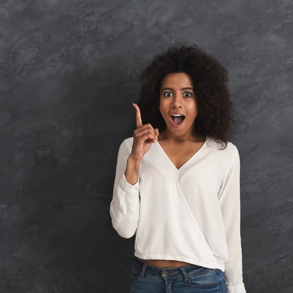 Excited black woman having new idea or plan