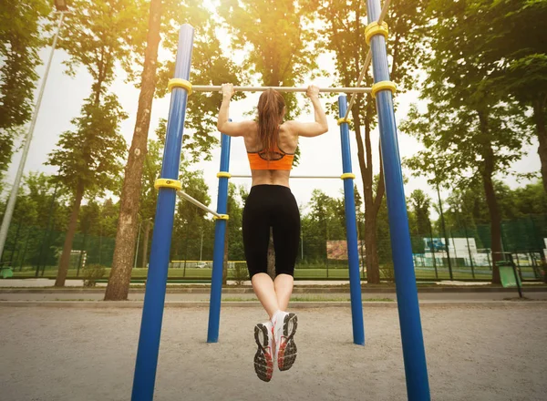 Chica haciendo ejercicio en el campo de deportes en el parque — Foto de Stock