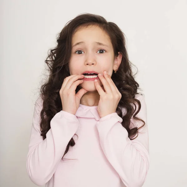 Little nervous girl biting her finger nails — Stock Photo, Image