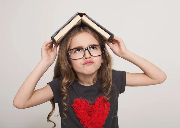 Menina cansada com telhado de livro — Fotografia de Stock