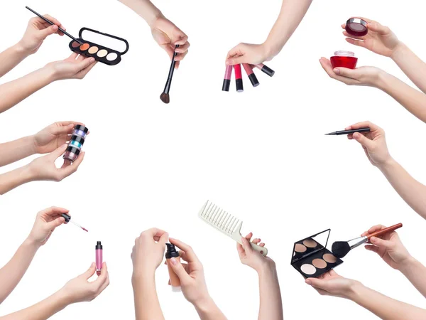 Set of makeup cosmetics in hands on white background — Stock Photo, Image