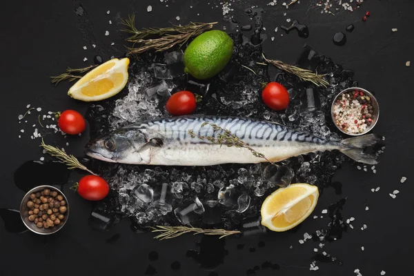 Mackerel and cooking ingredients on black background — Stock Image Mackerel and cooking ingredients on black background Royalty Free Stock Images