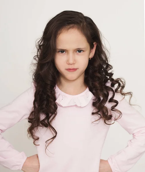 Grumpy little girl posing with hands on hips — Stock Photo, Image