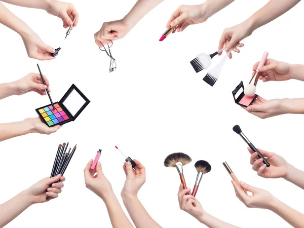 Set van make-up cosmetica in handen op witte achtergrond — Stockfoto