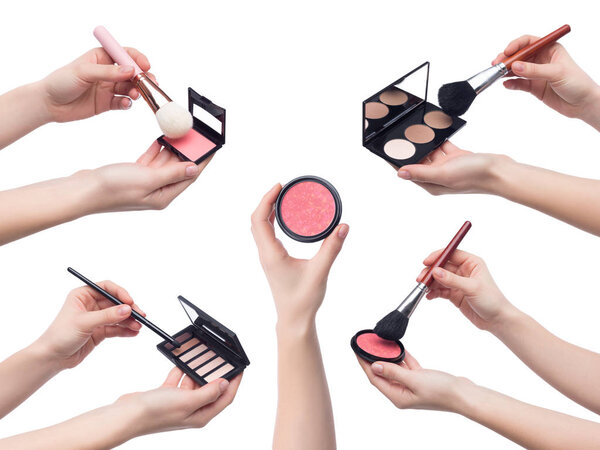 Set of makeup cosmetics in hands on white background