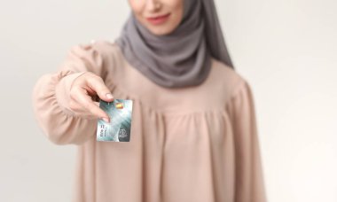 Non-cash transaction, arab woman giving credit card clipart