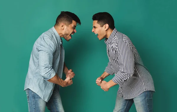 Two arab man shouting at each other at studio background — Stock Photo, Image