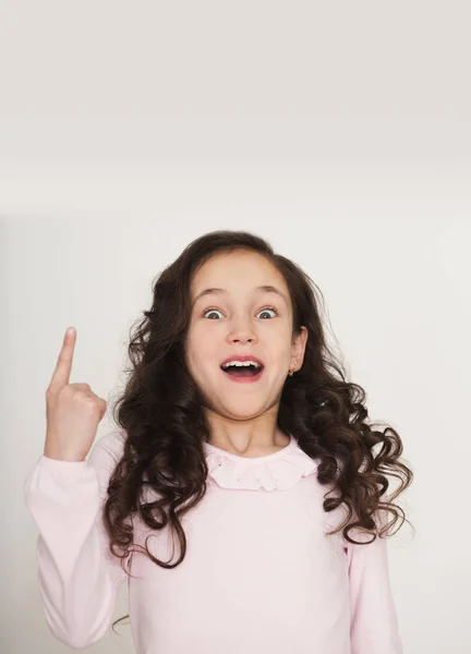 Excited little girl point finger up — Stock Photo, Image