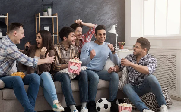 Podekscytowany przyjaciółmi oglądania meczu piłki nożnej w domu — Zdjęcie stockowe