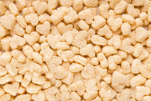 Sabrosos cereales blancos en forma de corazón fondo — Foto de Stock