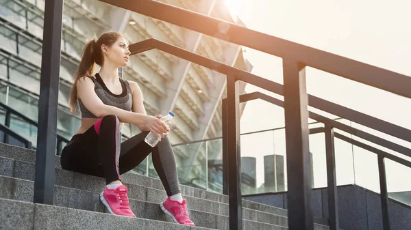 Mujer joven agotada sentada en las escaleras — Foto de Stock