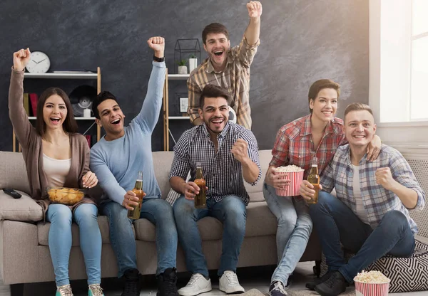 Friends yelling goal and raised fists at home — Stock Photo, Image