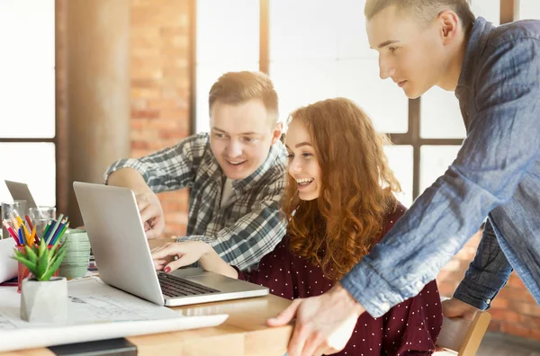 Laptop ile modern ofiste çalışan genç tasarımcılar