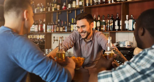 Uomini che bevono birra e comunicano con il barista — Foto Stock