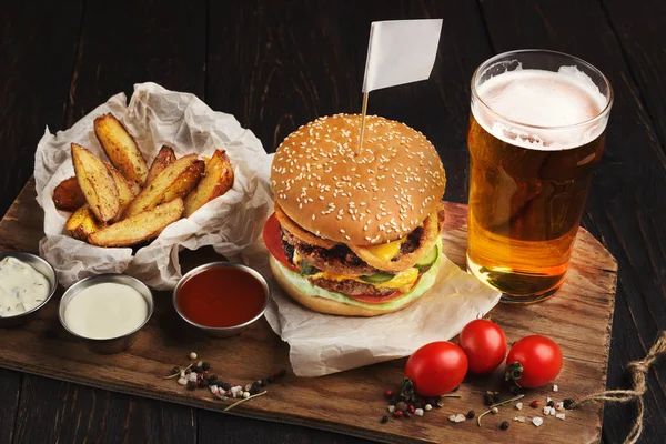 Hamburger made of beef and beer on wooden cutting board — Stock Photo, Image