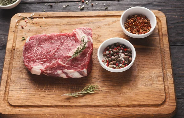 Filé de carne crua mignon bife na placa de madeira — Fotografia de Stock