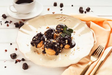 Çikolata sosu ve nane yaprakları ile Fransız profitroles