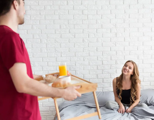 Manžel přiblížit radost ženě snídani v ložnici — Stock fotografie
