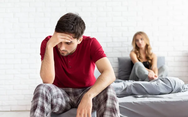 Problemas de cama. Hombre deprimido sentado en la cama en el dormitorio —  Fotos de Stock