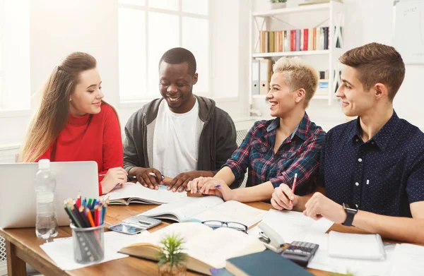 Group of diverse students studying at wooden table — Stock Photo, Image