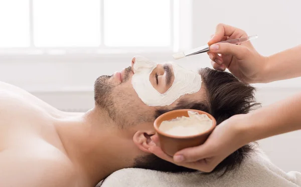 Man getting facial nourishing mask at spa salon — Stock Photo, Image