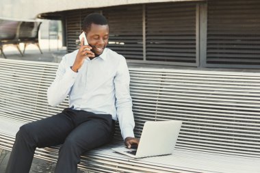 Afrika kökenli Amerikalı işadamı dizüstü bilgisayar açık havada ile çalışma