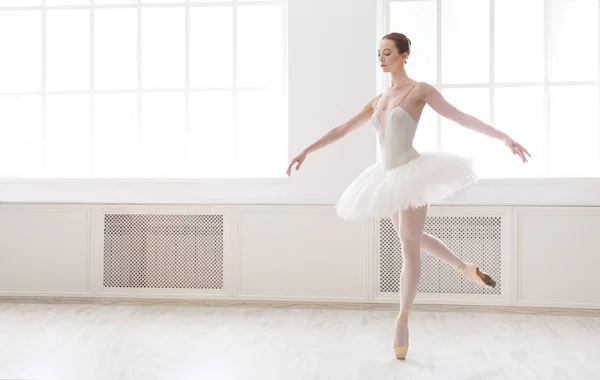 Beautiful ballerina in tutu skirt near large window — Stock Photo, Image