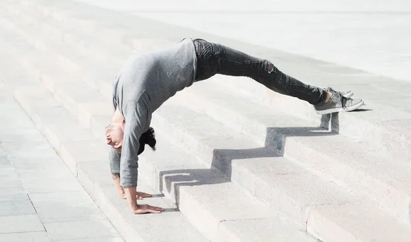 Sporty man doing advanced yoga asana outdoors — Stock Photo, Image