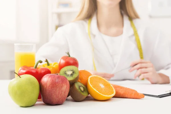 Nutritionist desk with fruit and measuring tape — Stock Photo, Image