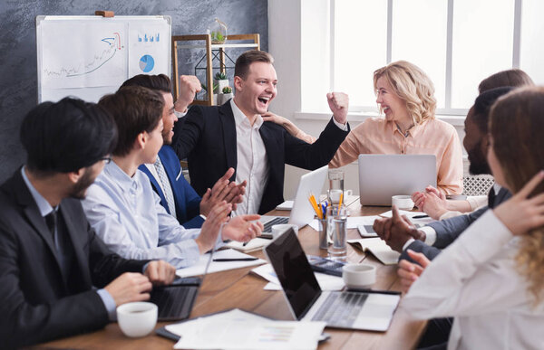 Business people congratulate colleague with his success