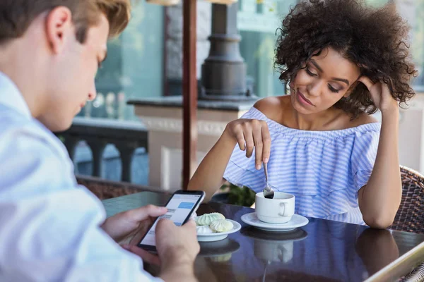 Young woman bored while her boyfriend using mobile phone — Stock Photo, Image