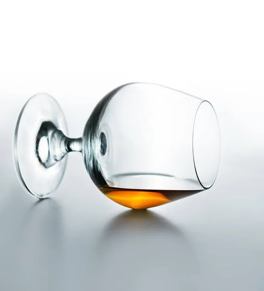 Verre avec cognac couché sur le dessus de la table — Photo