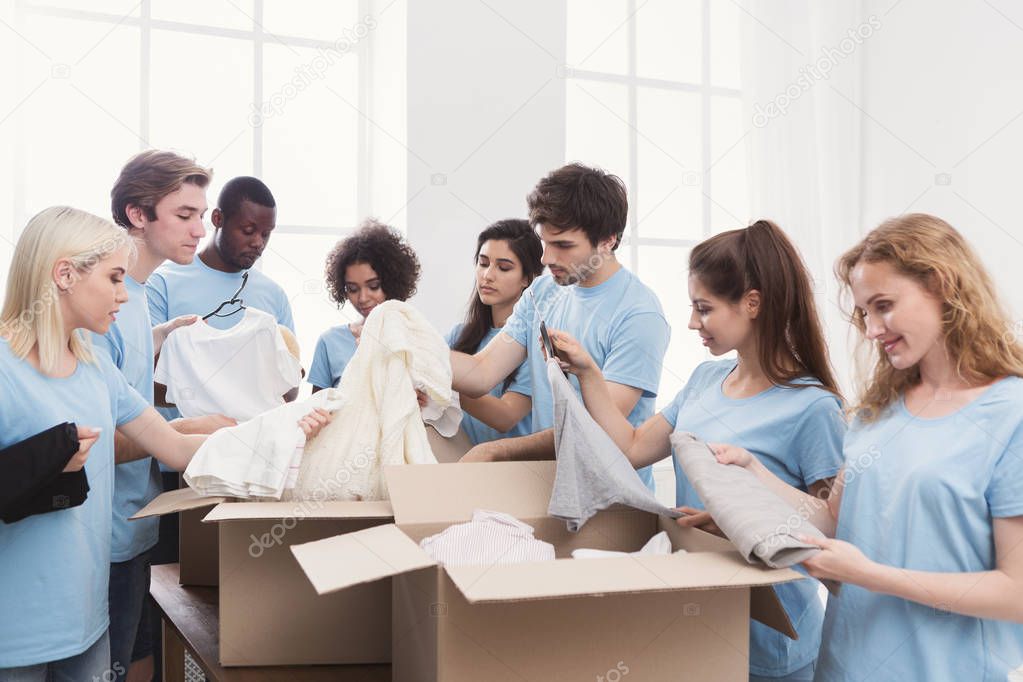 Young volunteers group working with clothing donation