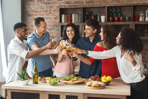 Amis heureux boire et manger ensemble dans la cuisine — Photo