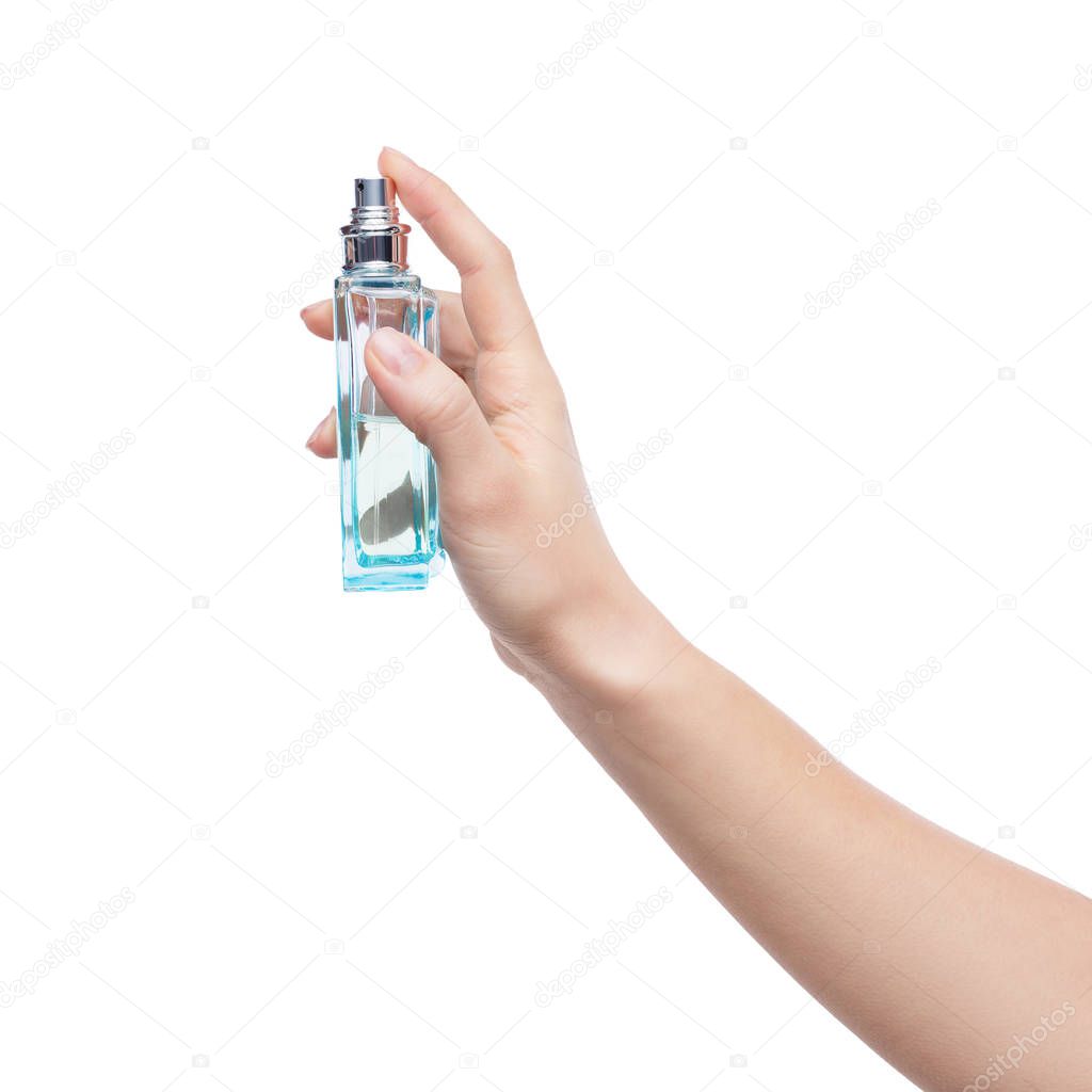 Young woman holding bottle of perfume isolated on white