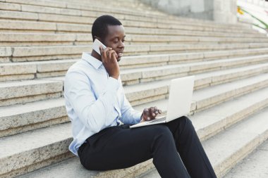 Afrikalı-Amerikalı mutlu işadamı dizüstü bilgisayar açık havada ile çalışma