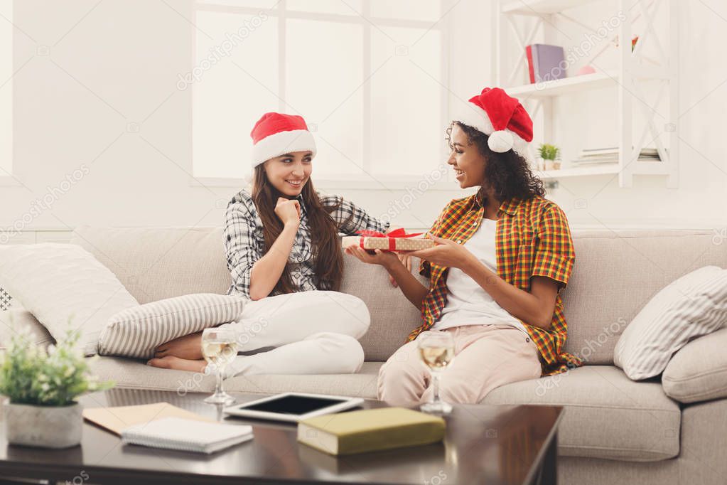 Excited woman getting gift from her friend