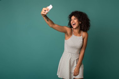 Mutlu kadın mavi arka plan üzerinde video kayıt